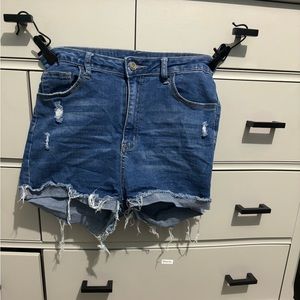 Blue jean shorts. Stretchy. Black pockets.